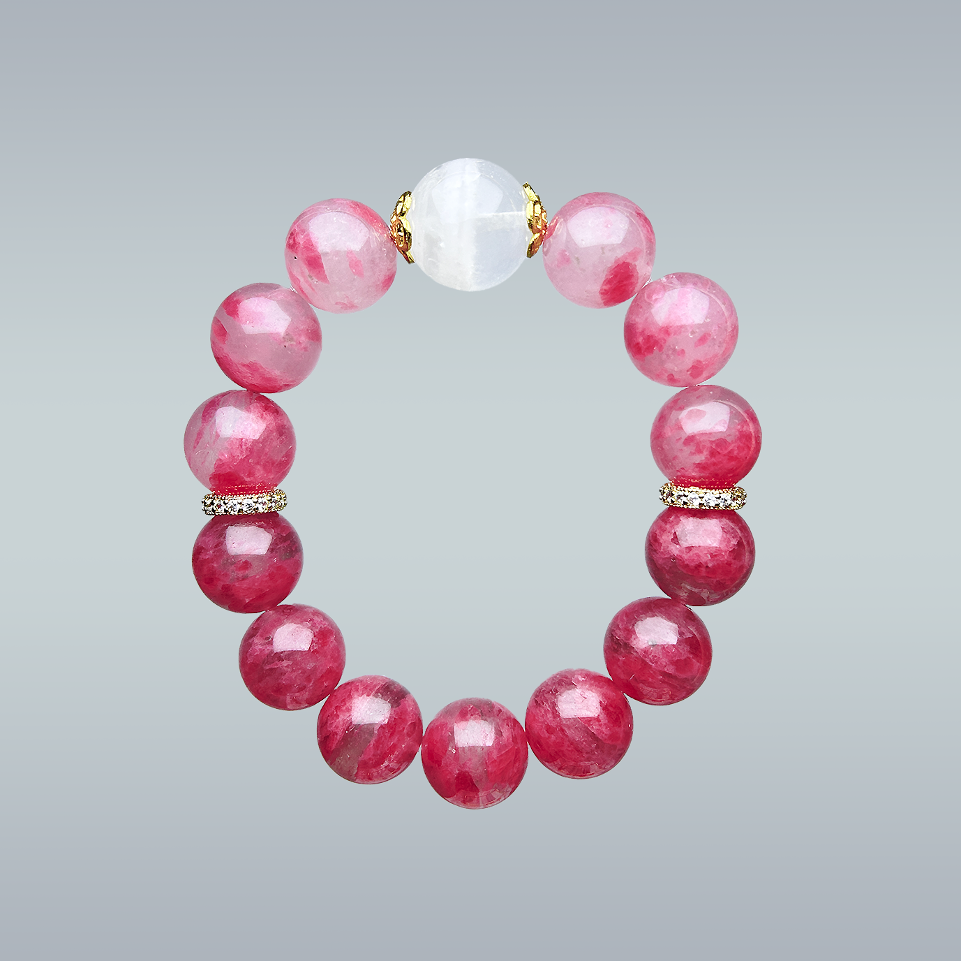 Hang lay of Phantom Quartz and pink Rhodonite bracelet with gold spacers on neutral background