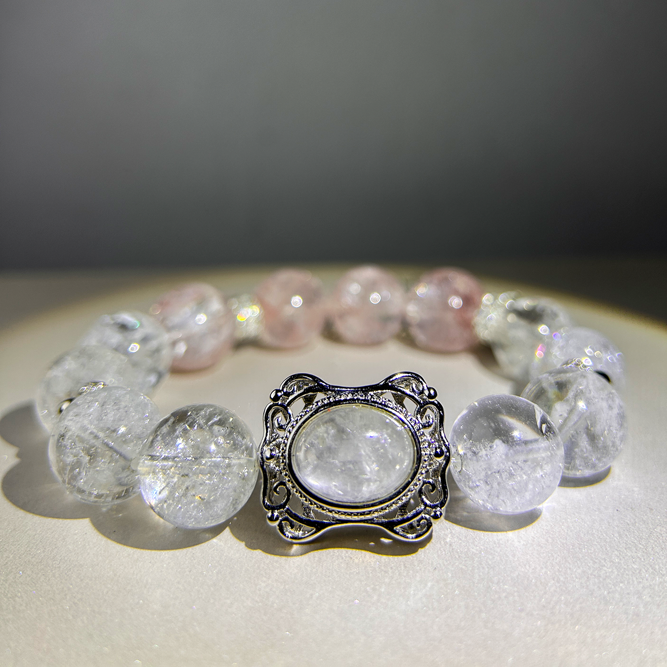 Close-up of rutilated quartz centerpiece framed in silver on the Blossom Valley bracelet.