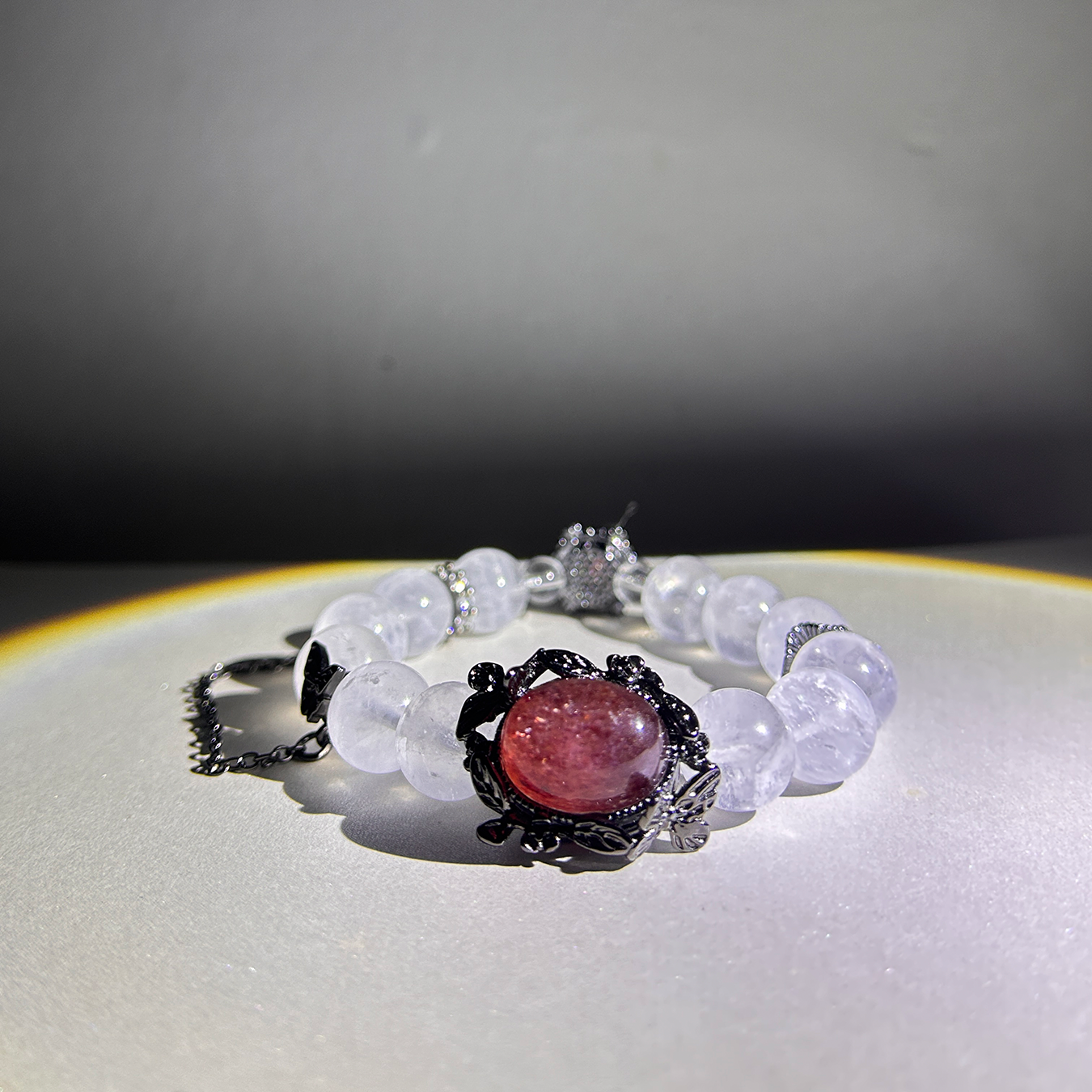 Blushing Elegance bracelet highlighting red sunstone gem and translucent quartz glow.