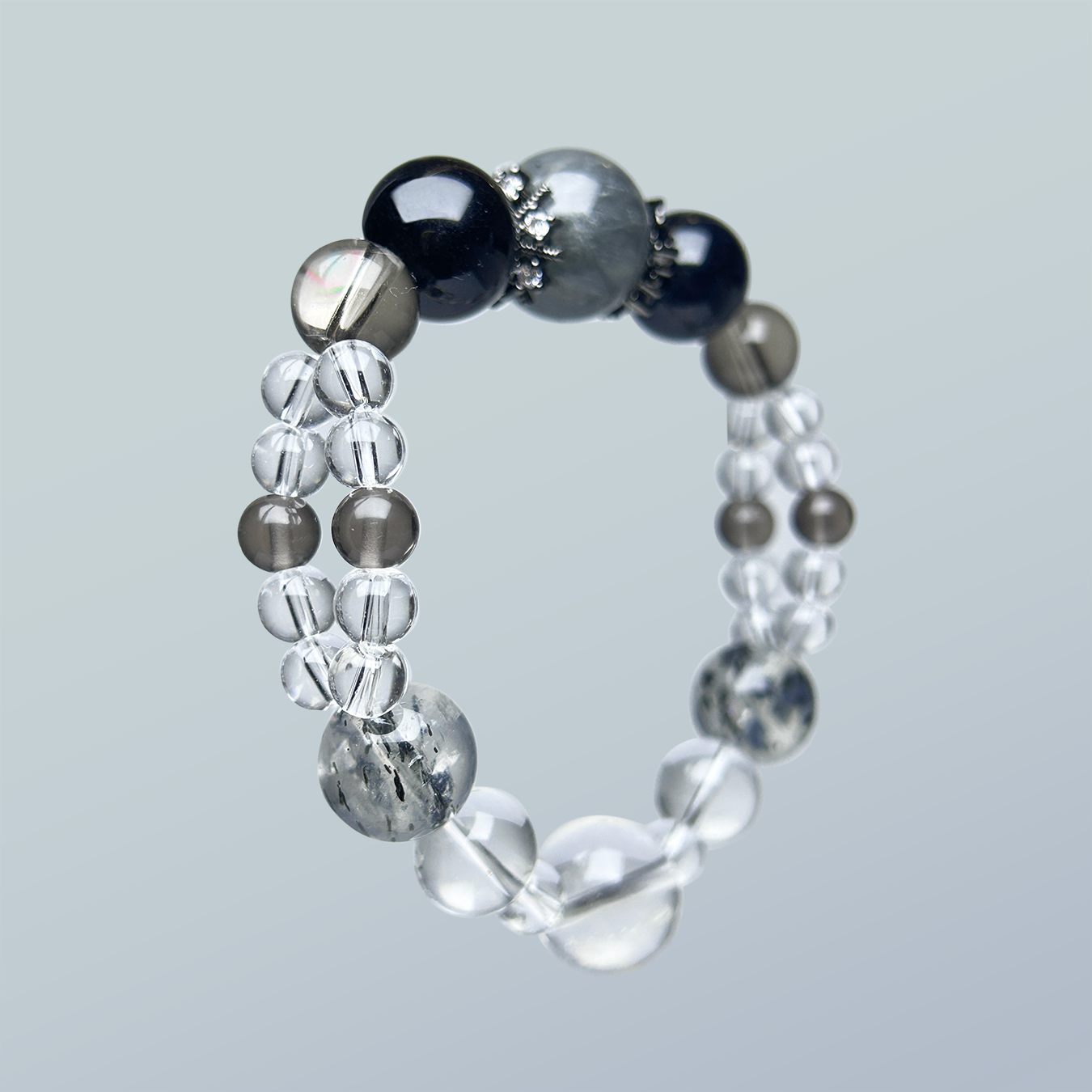 Double-row crystal bracelet with smoky quartz, clear quartz, black obsidian, blue tiger’s eye, and rabbit hair rutilated quartz centerpiece