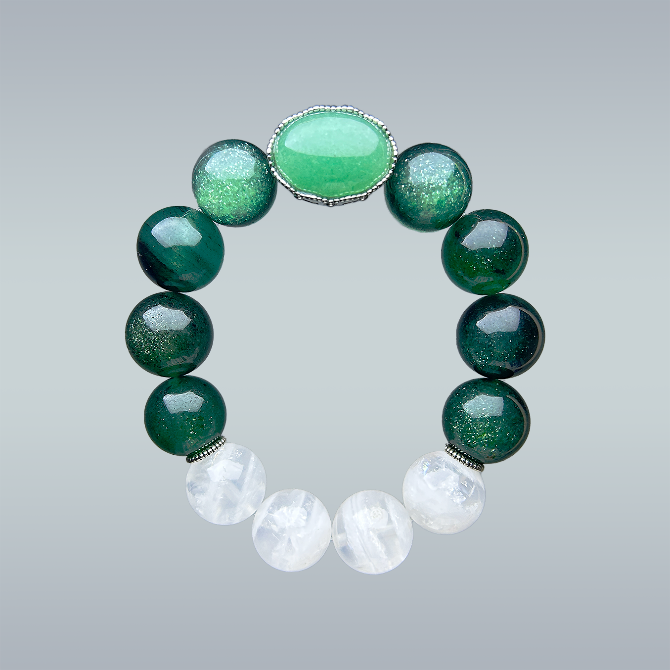 crystal bracelet featuring a central oval aventurine stone, flanked by glittery green strawberry quartz and white phantom quartz beads, displayed on a soft grey gradient background.