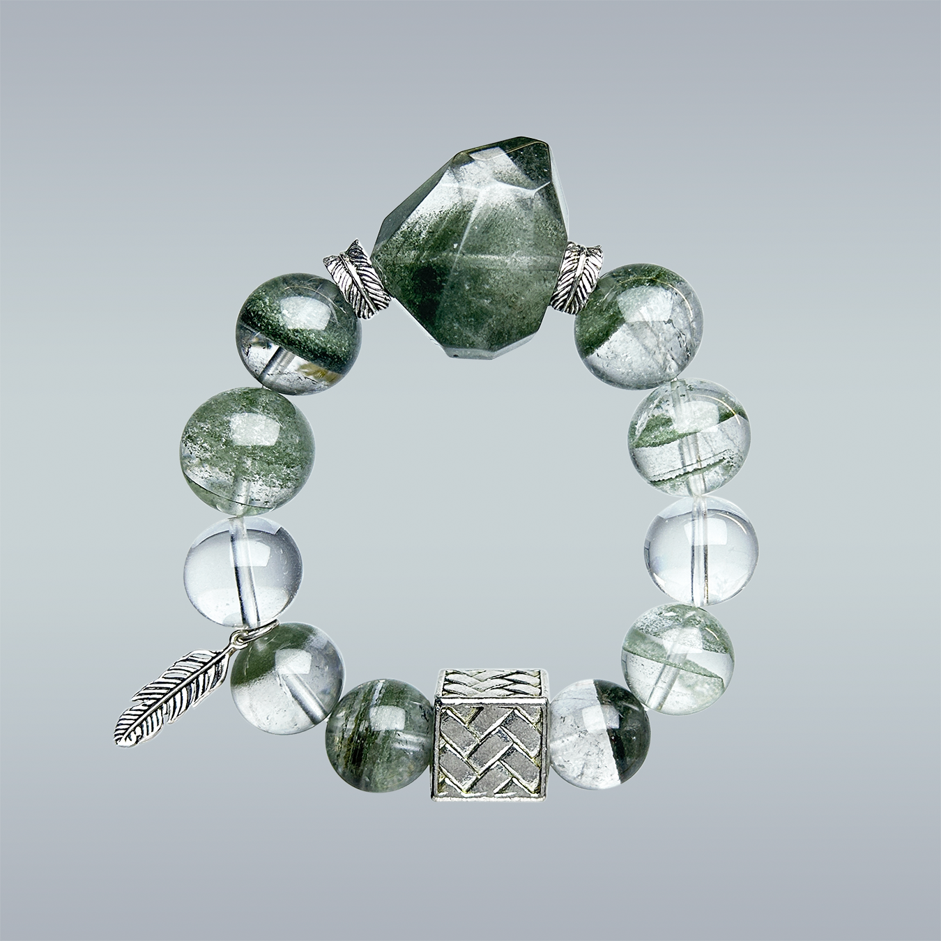 Product photo of handmade Green Phantom and Clear Quartz bracelet with silver feather charm