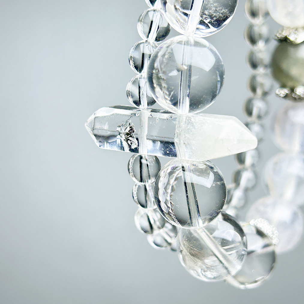 Close-up of double-layer crystal bracelet with Clear Quartz centerpiece with dual linkage points and polished round beads