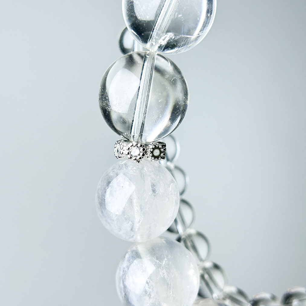 Detailed view of Clear Quartz and White Rabbit Hair Rutilated Quartz with silver rhinestone spacer