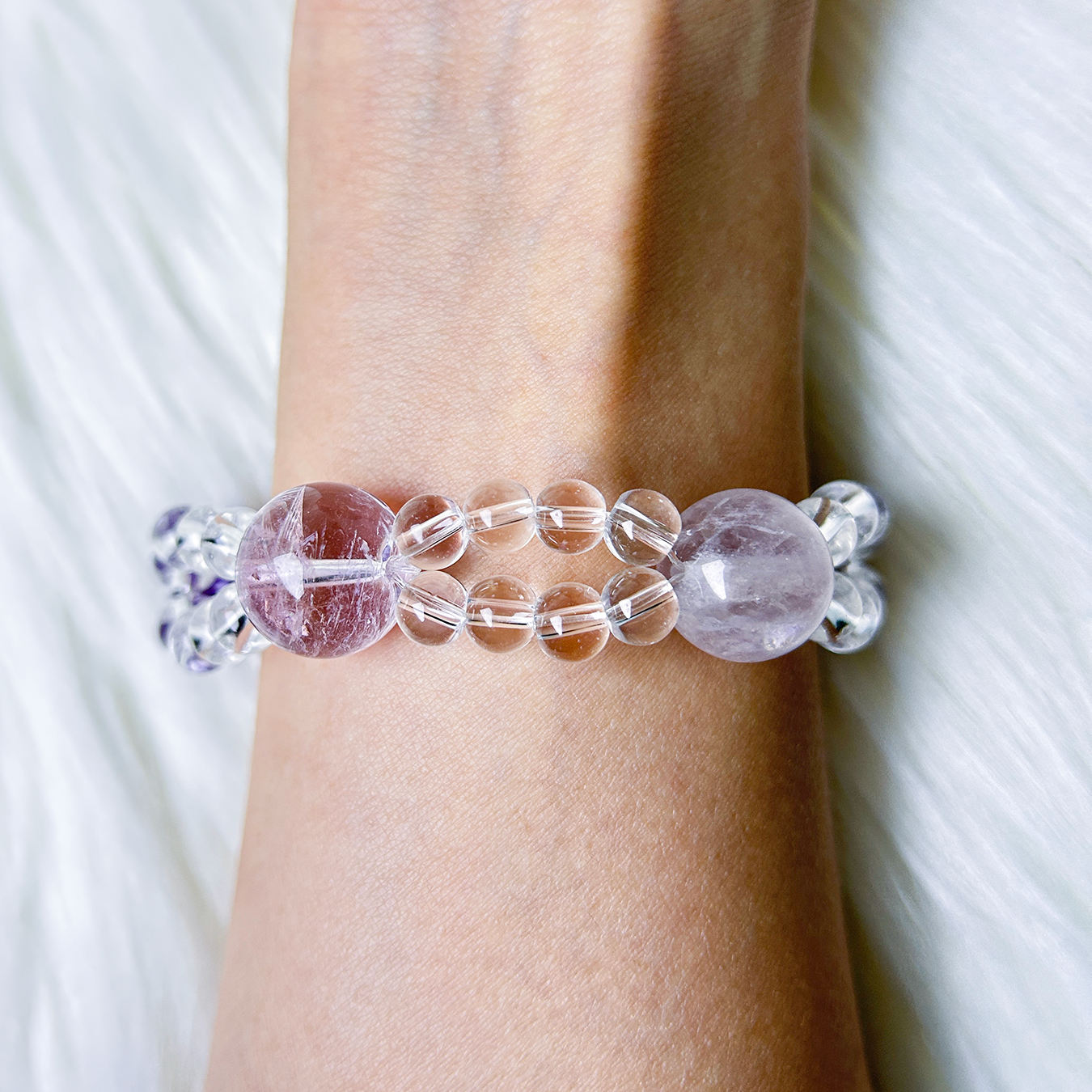 Double layered purple crystal bracelet made with amethyst and clear quartz worn on wrist back view