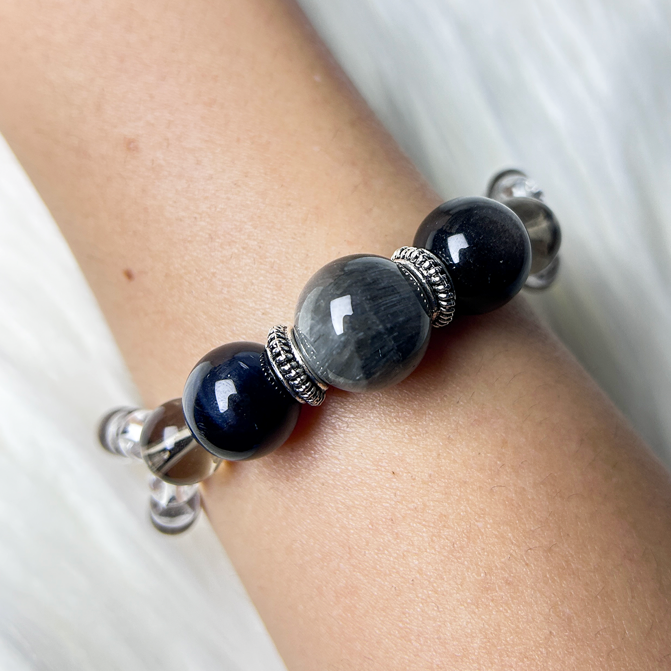 gray rabbit hair rutilated quartz beaded bracelet with silver spacers, energy healing jewelry for grounding.