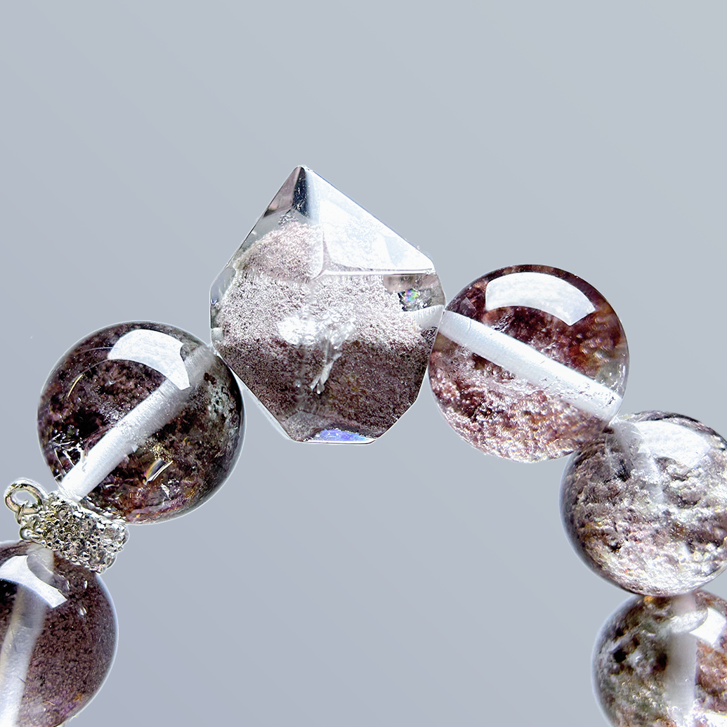 Close-up on the pointed centerpiece of Phantom Quartz bracelet, capturing the translucent structure and natural texture.
