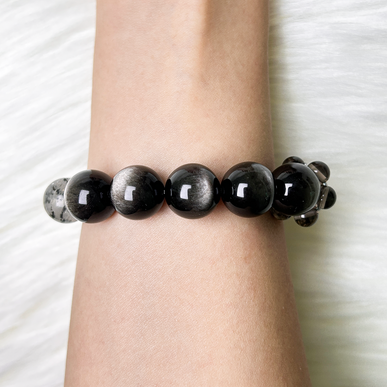 Back view of Monochrome Vein bracelet showing smooth black obsidian beads with subtle metallic reflections