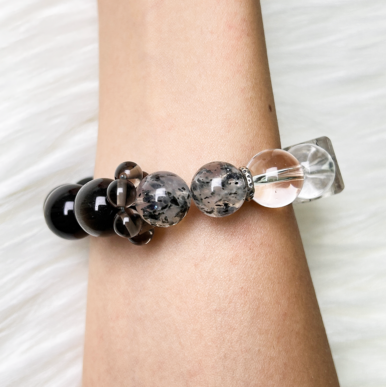 Side view of Monochrome Vein bracelet highlighting smoky quartz and Biotite Mica beads on wrist side view.