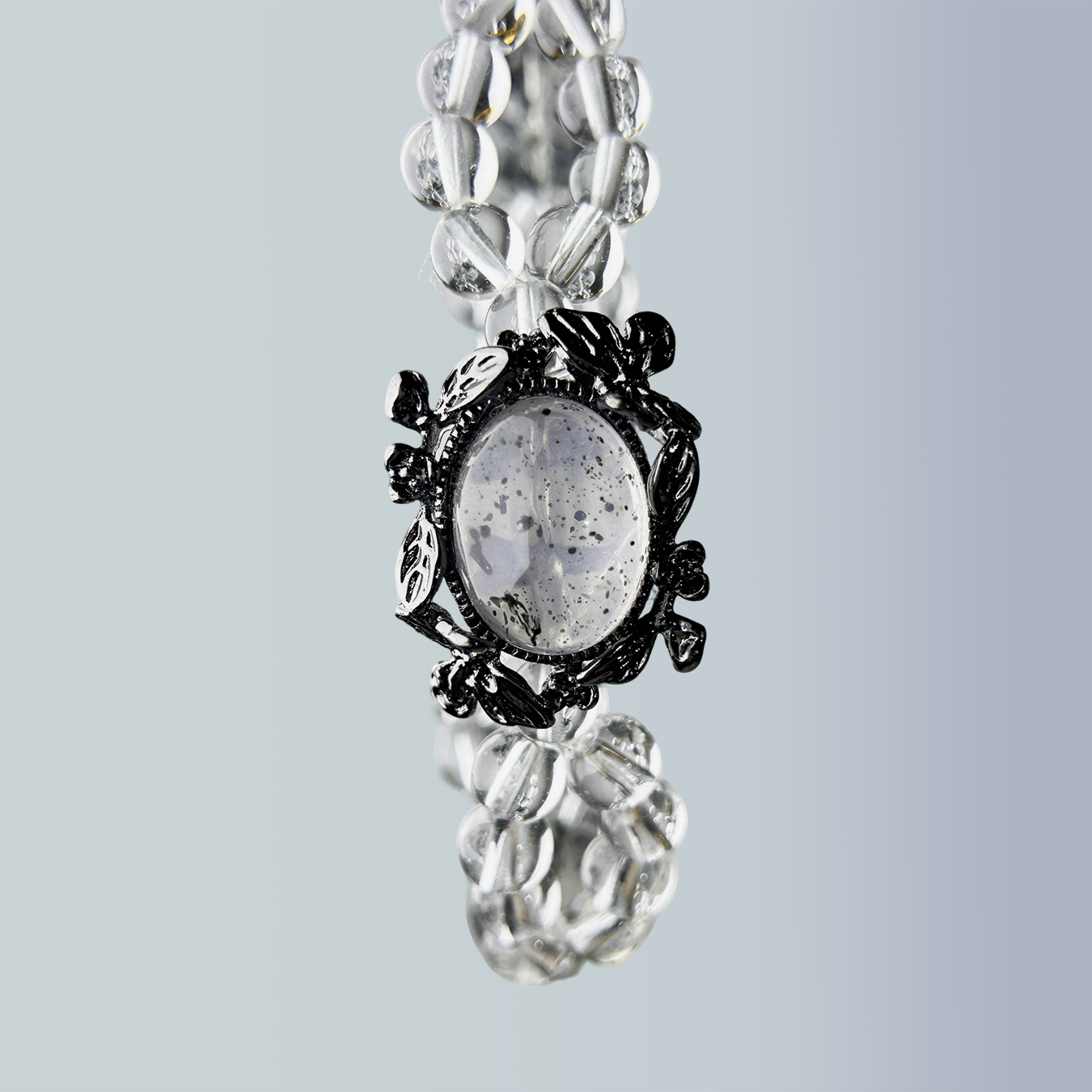 Close-up of Noir Mist bracelet showing Biotite Mica centerpiece with double clear-quartz strands.