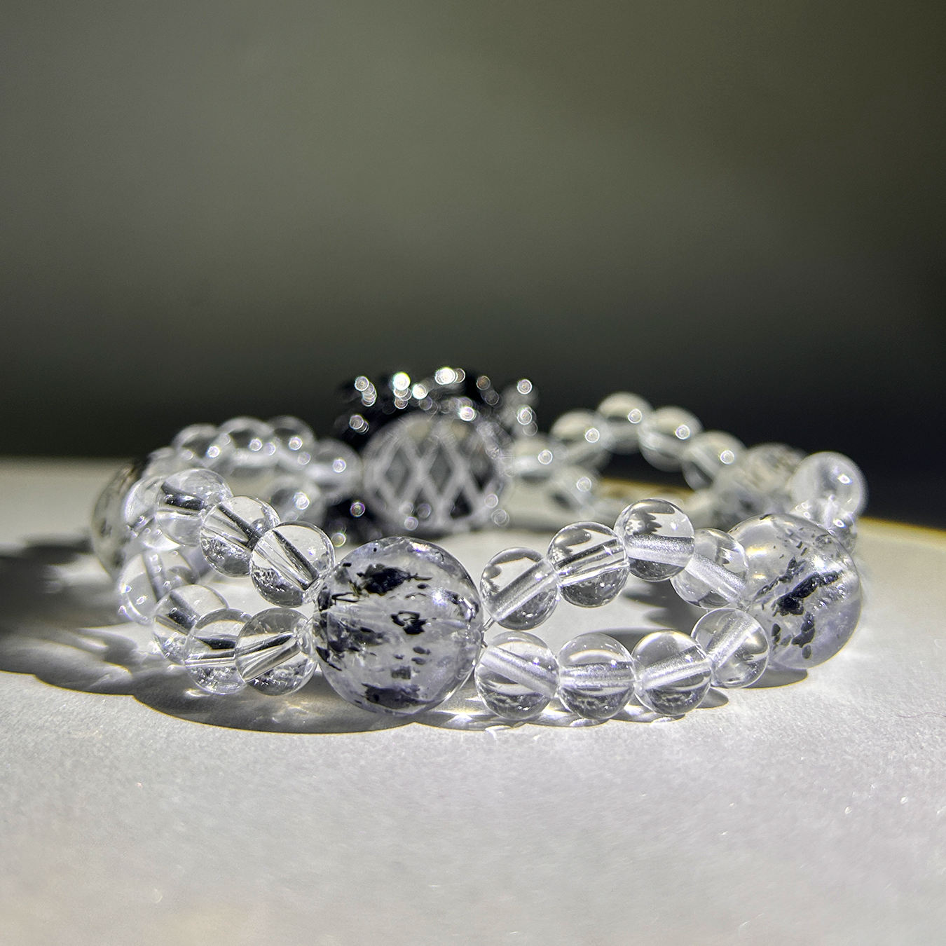 Back view of Noir Mist bracelet with polished Biotite Mica and luminous clear-quartz reflections.