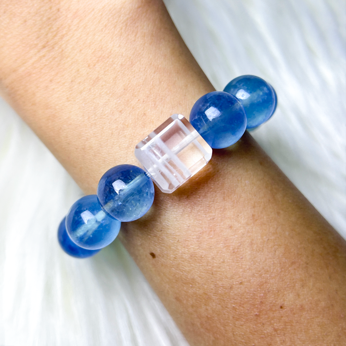 Aquamarine bracelet with White Phantom Quartz cube worn on wrist