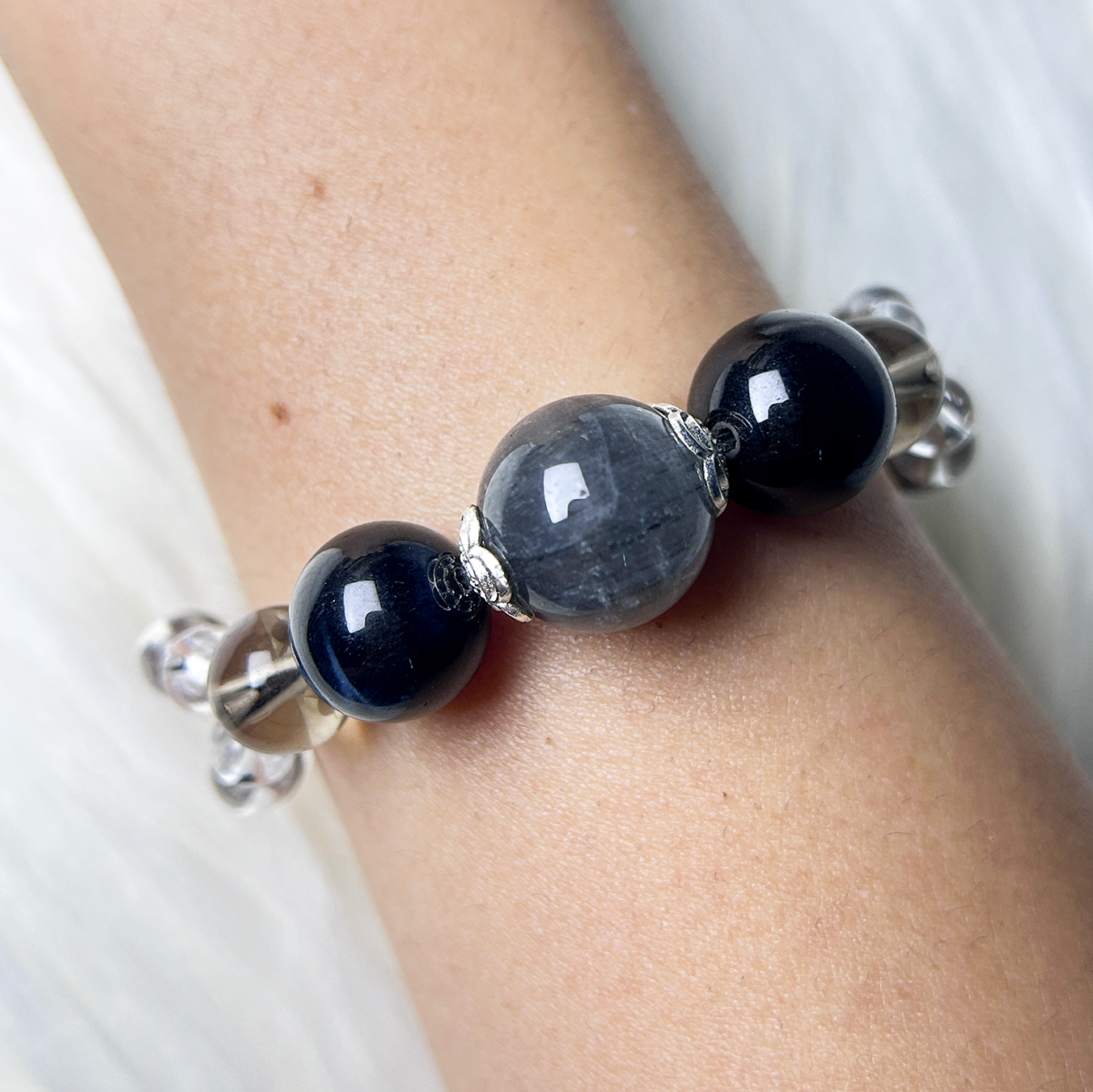 Natural crystal bracelet with polished beads on wrist, handmade earth tone gemstone bracelet.
