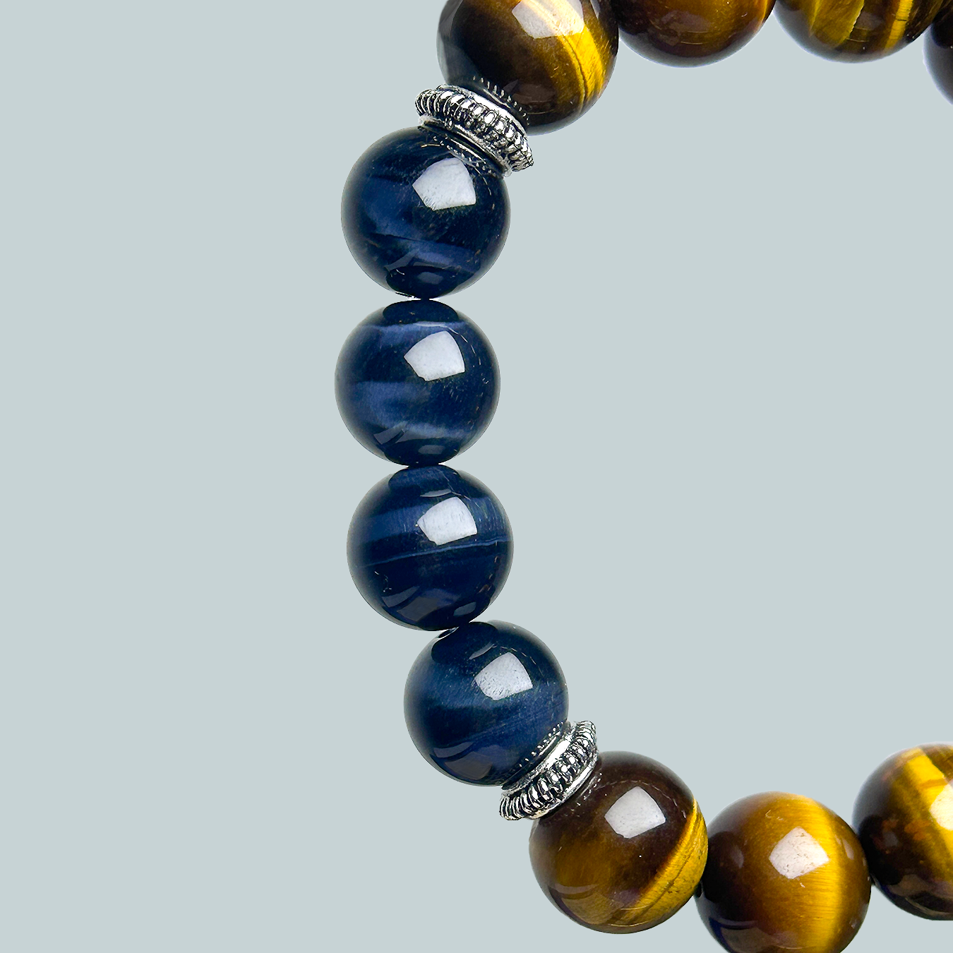 close up blue tiger's eye part with silver spacers in a yellow tiger's eye bracelet for men