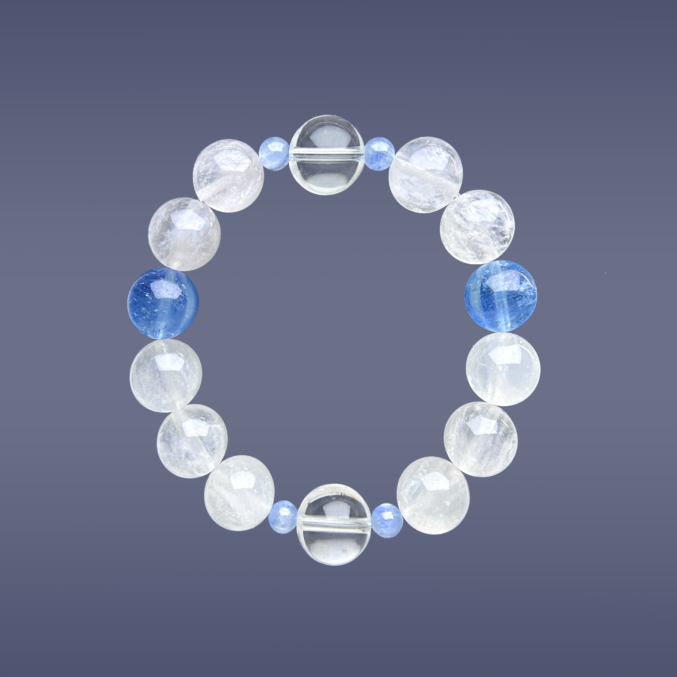 Hang lay of Aquamarine, Clear Quartz, and White Rabbit Hair Rutilated Quartz crystal bracelet on blue background.