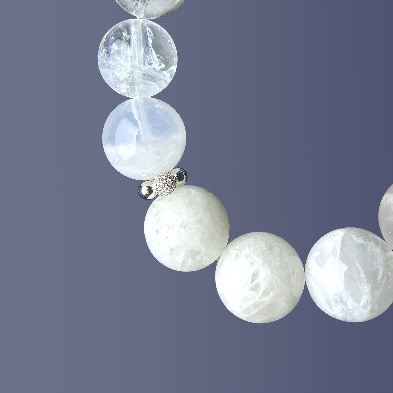 Detailed side view of white phantom quartz and silver charm spacer, showcasing the soft cloudy texture and faceted surface of the gemstone.