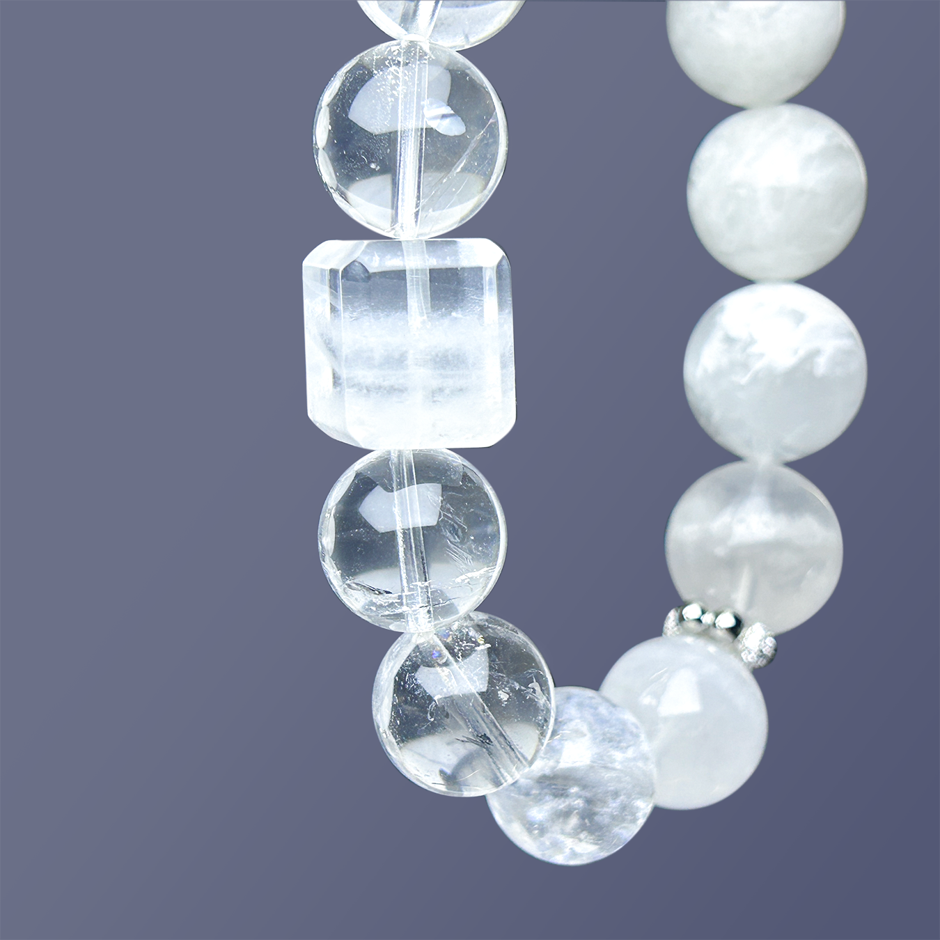 Close-up of the rectangular clear quartz centerpiece surrounded by round clear quartz beads, highlighting the clarity and cut of the crystals.