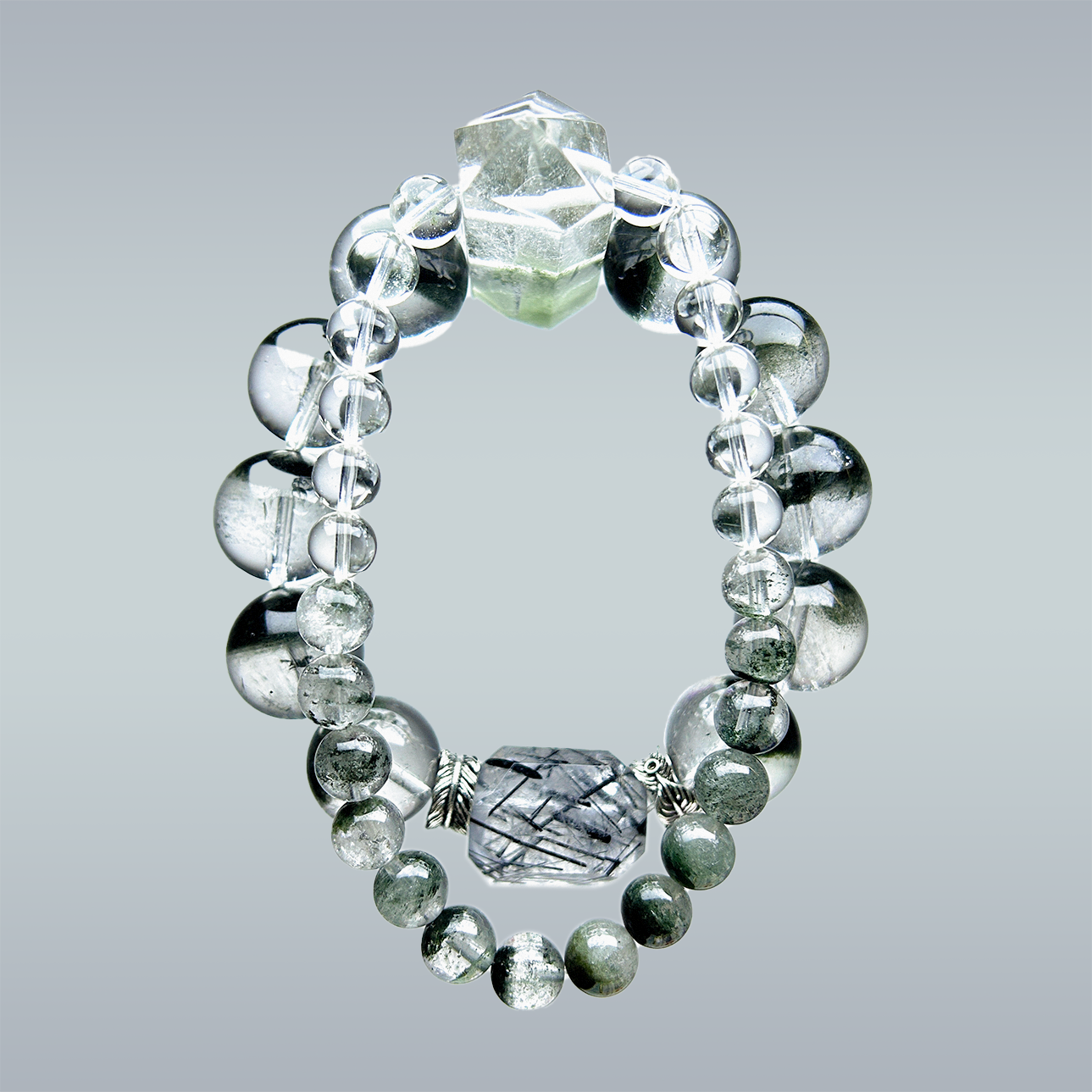 Hang lay of Green Phantom Quartz bracelet with clear rutilated quartz and pointed crystal charm