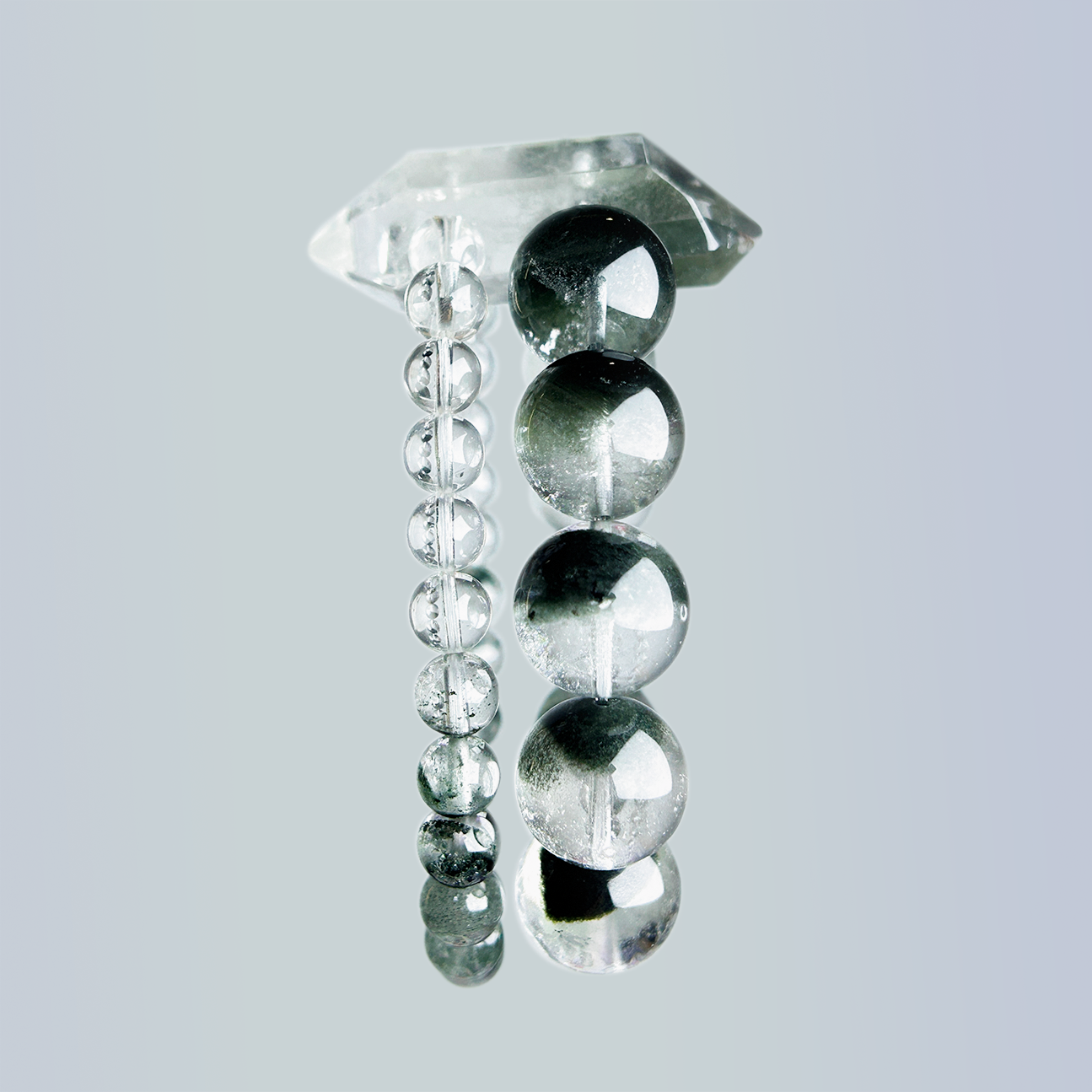 Side view of Green Phantom Quartz and Clear Quartz double-strand bracelet with round beads