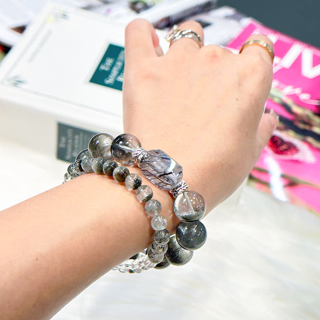 Top-down wrist view of Clear Rutilated Quartz and Green Phantom Quartz bracelet with crystal centerpiece