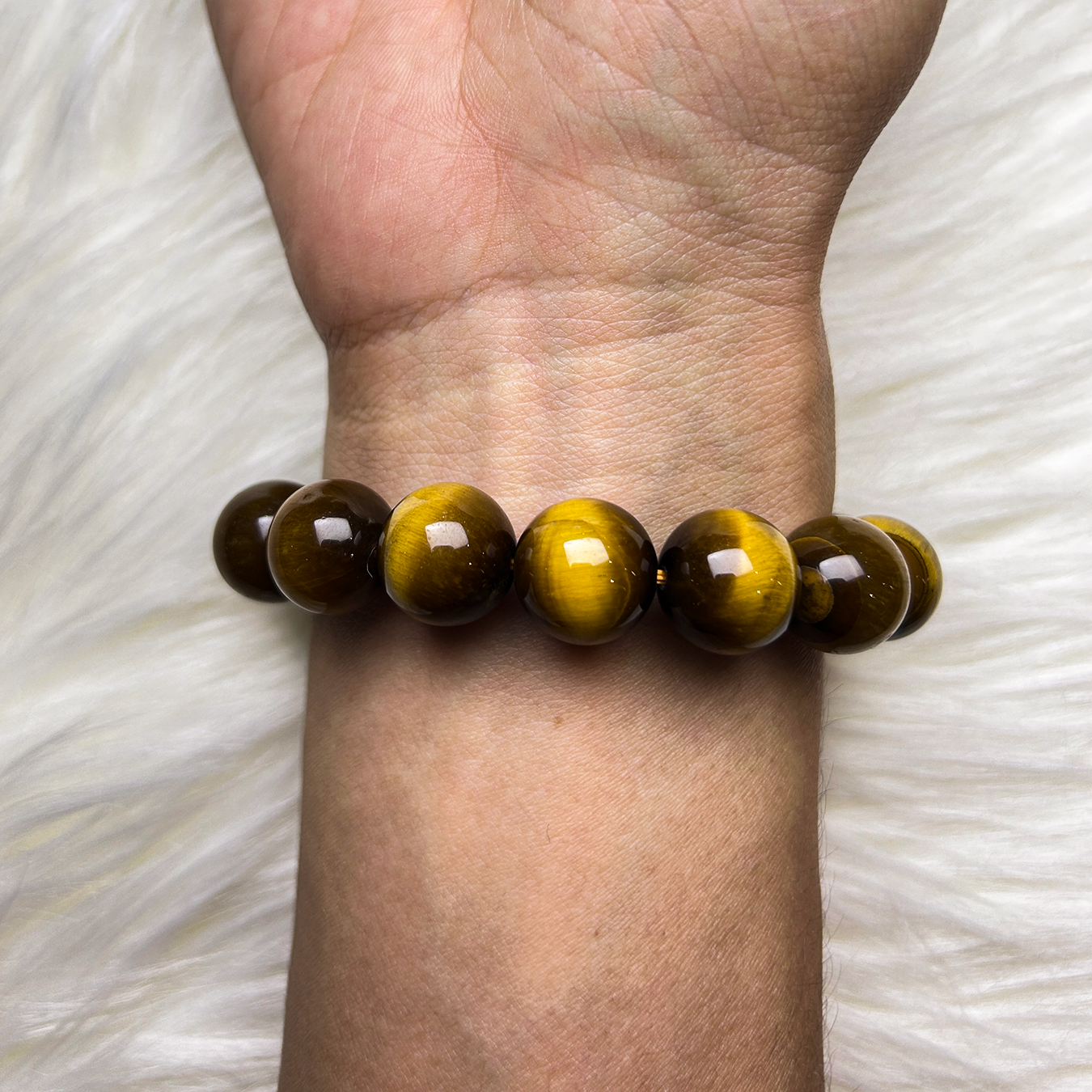 Warrior’s Forge bracelet made with polished yellow tiger’s eye beads worn on wrist back view.